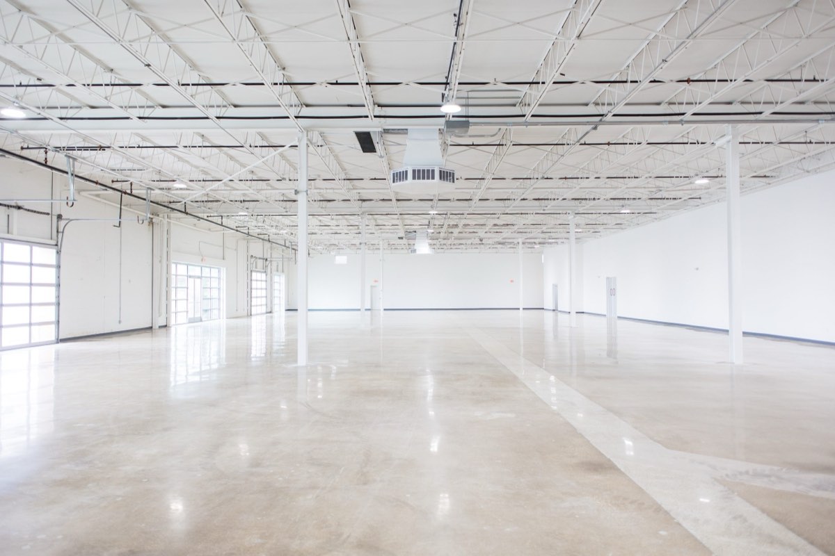 The empty main hall at Astoria Event Venue — 12,500 square feet of polished floor under 18-foot ceilings